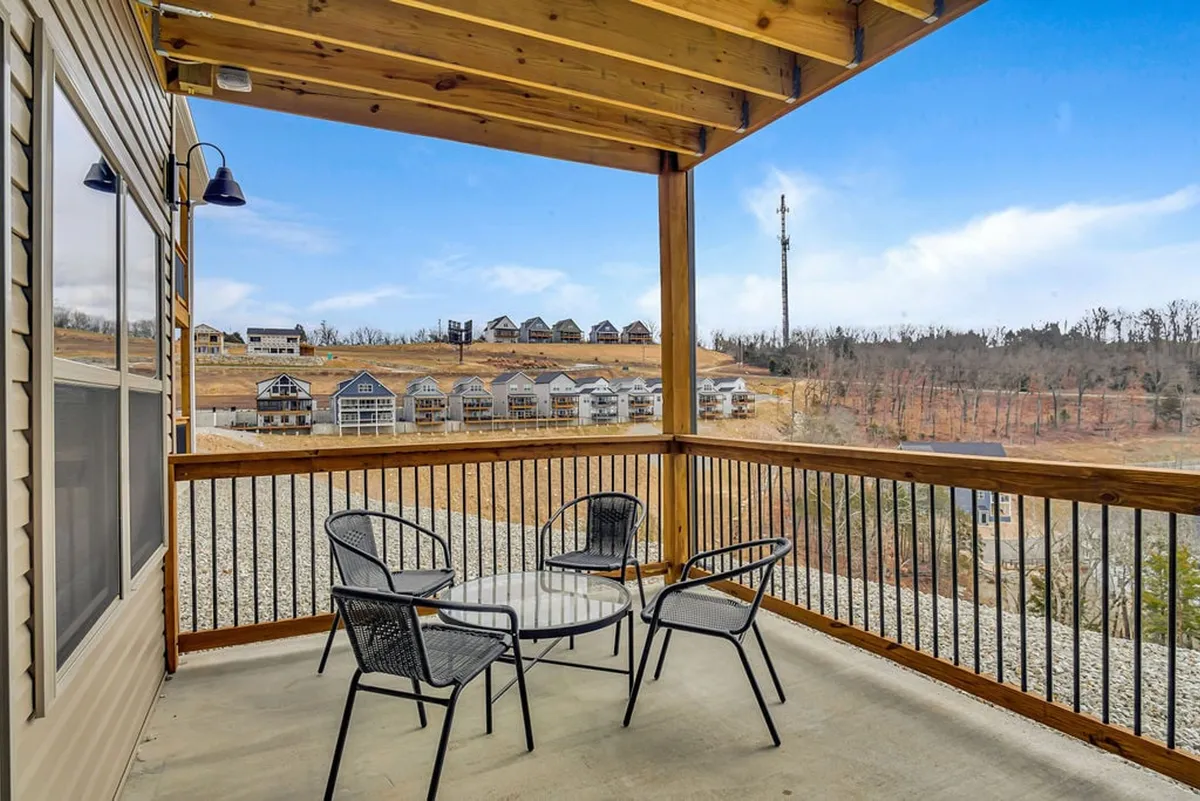A peaceful outdoor seating area under wooden beams, with scenic views of the natural surroundings. The space is designed for relaxation, socializing, and connecting with nature, with plenty of room to enjoy morning coffee, sunsets, or quiet contemplation.